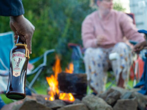 Abercastle Campsite, people relaxing around a firepit.
