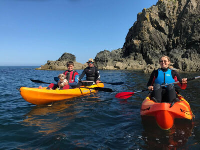 Anne, guests and a small dog Kayaking at beautiful Abercastle Pembrokeshire, West Wales.